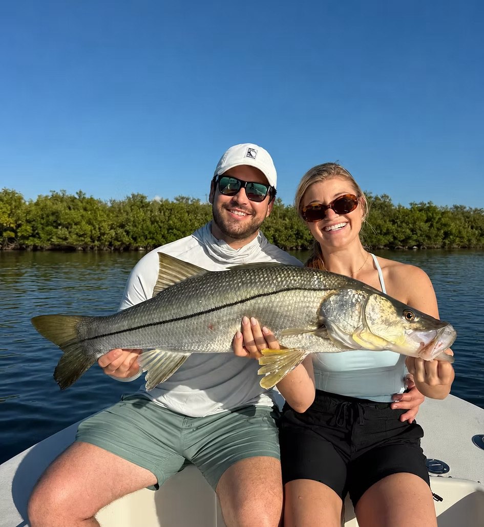 Anglers with a trophy snook caught in the Indian River Lagoon
