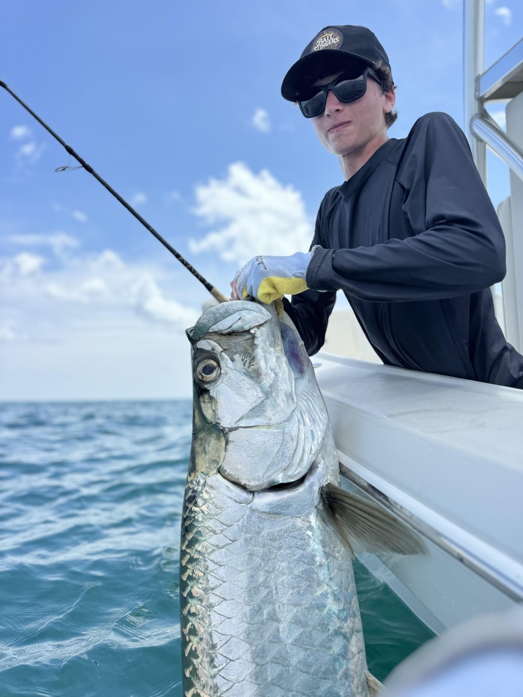 Angler boatside with a silver king tarpon off the Florida coast